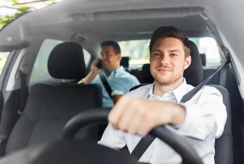 Driver and passenger belted into the front seats of a commercial passenger vehicle